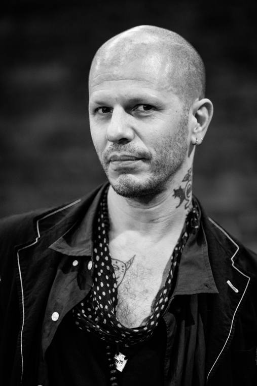 Dan Safer, black-and-white portrait, looking sideways at the camera