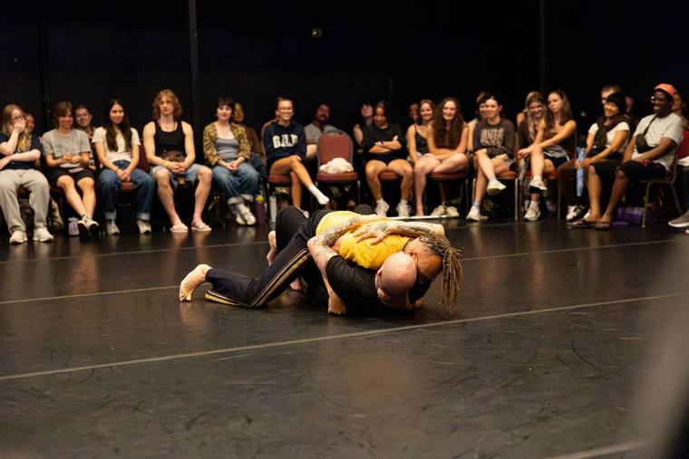 Particles, Fields and The Void: Dan Safer and Thomas F. DeFrantz locked together on the floor as an audience watches