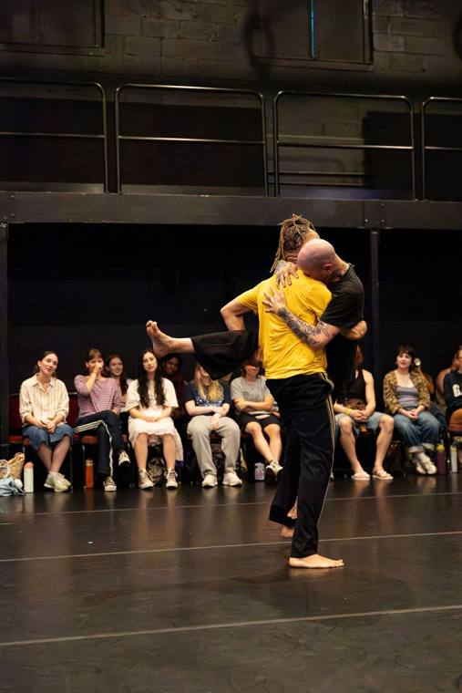 Thomas F. DeFrantz lifts Dan Safer in a full embrace