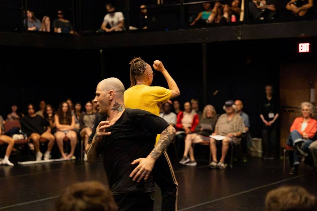 Particles, Fields and The Void: Dan Safer rushes past Thomas F. DeFrantz, whose fist is raised