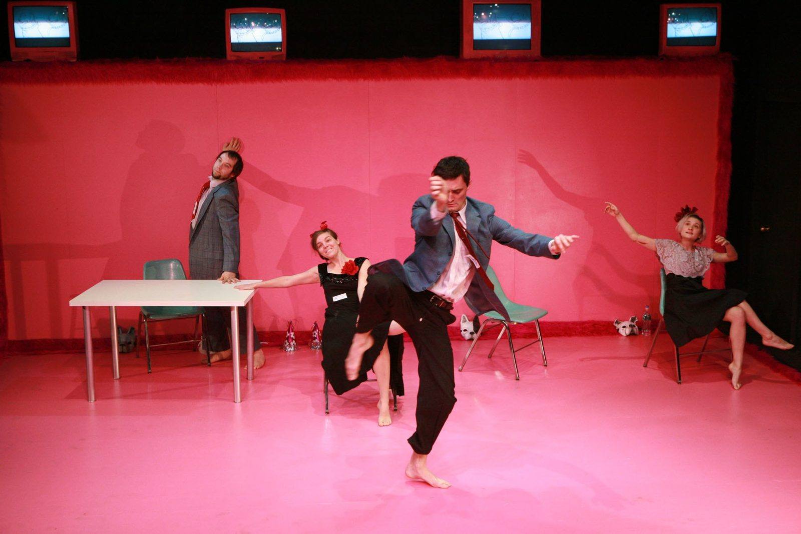 Vicious Dogs on Premises: dancers on a bright pink set beneath old TVs
