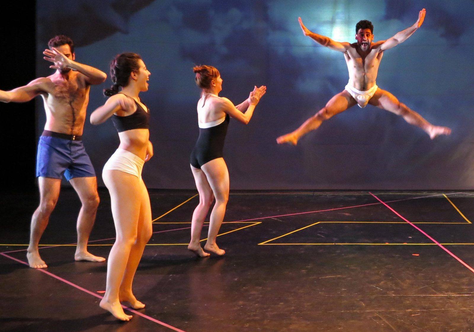 Eterniday: a man mid star-jump, screaming, as three dancers cheer