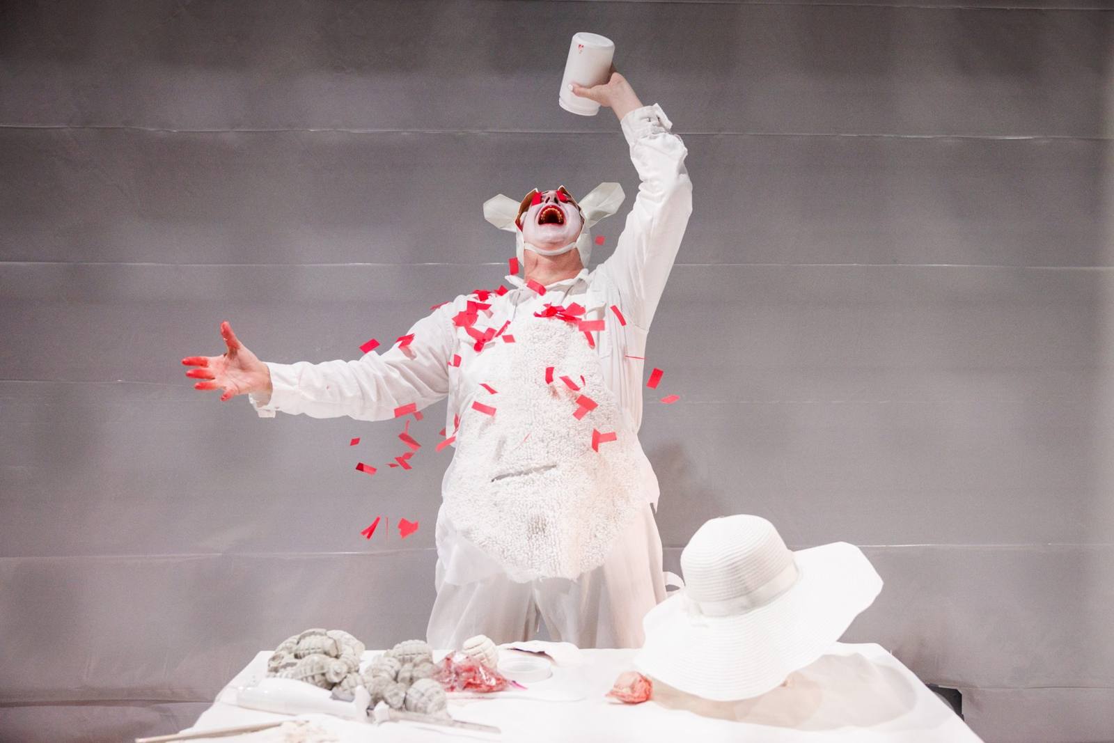 Spider Rabbit: Tony Torn howls upward as red confetti bursts over his white suit